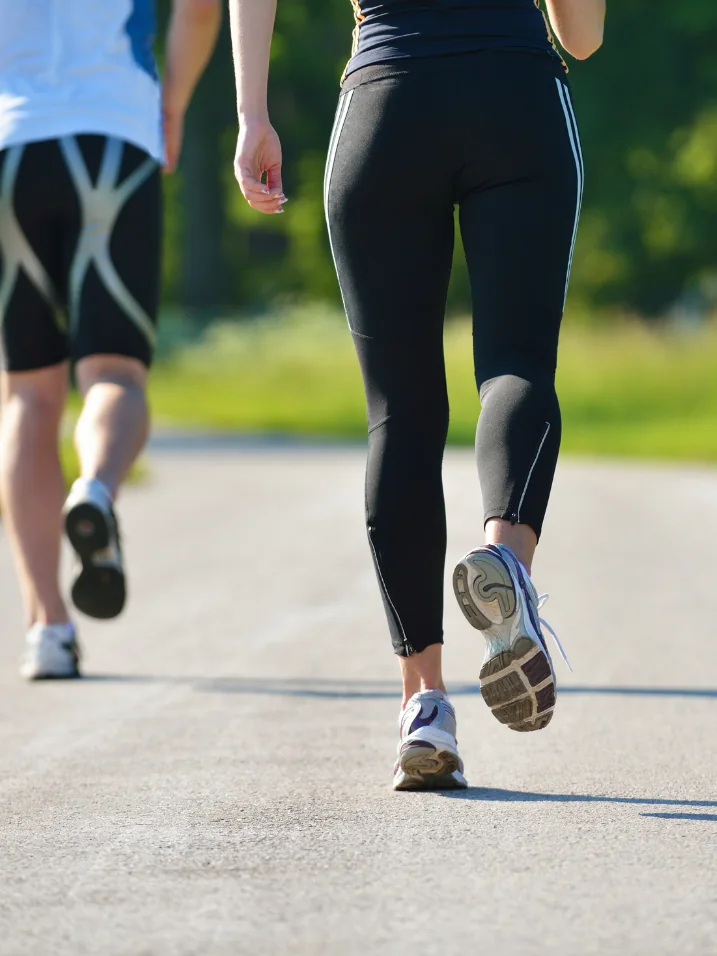 Runners’ legs mid-stride on a road